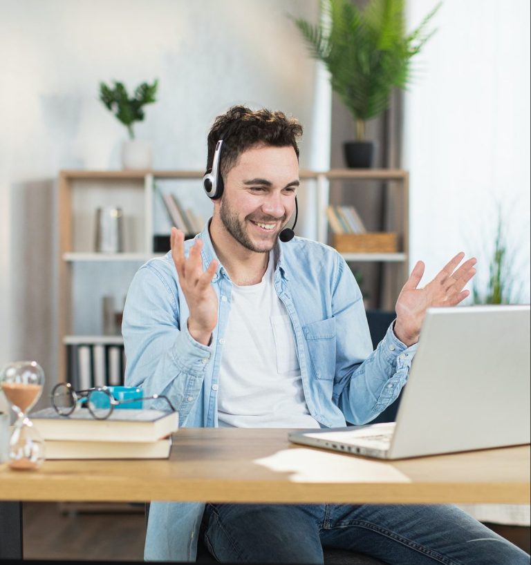 Man in headset having video conference on modern laptop